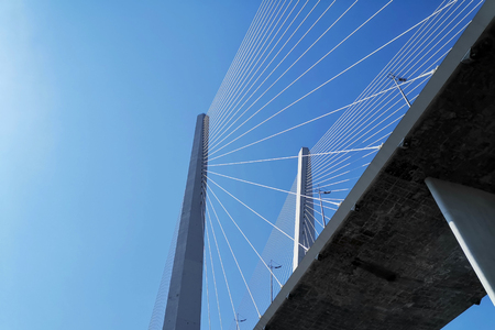 Vladivostok, Primorsky Krai - April 3, 2019: Cityscape overlooking the Golden bridge against the blue sky.の写真素材