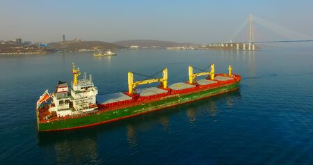 Vladivostok, Primorsky Krai - April 21, 2019: The Eastern Bosphorus Strait to ships on the background of the Russian bridge.のeditorial素材
