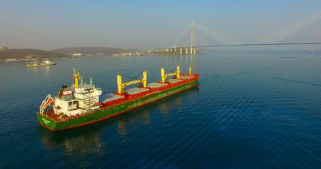 Vladivostok, Primorsky Krai - April 21, 2019: The Eastern Bosphorus Strait to ships on the background of the Russian bridge.のeditorial素材