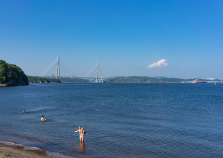 Vladivostok, Russia - August 19, 2018: Seascape overlooking the beach and the Russian bridge on the horizon.のeditorial素材