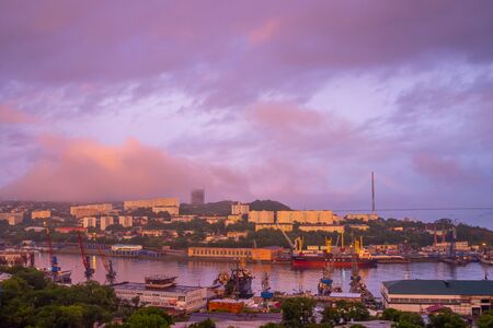 Vladivostok, Primorsky Krai - June 20, 1019: Pink sky above the evening cityscapeのeditorial素材