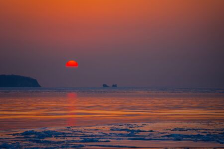 Seascape ice beach and the red sunset.の写真素材