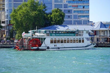 Sevastopol, Crimea-June 8, 2016: Large commercial catamaran on the background of the sea and the waterfront of the city.のeditorial素材