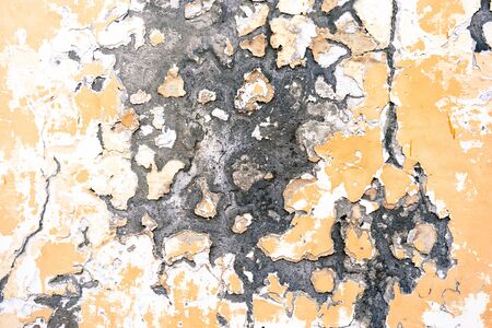 Abstract yellow wall background with scuffs and cracksの写真素材