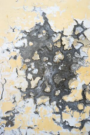 Abstract yellow wall background with scuffs and cracksの写真素材