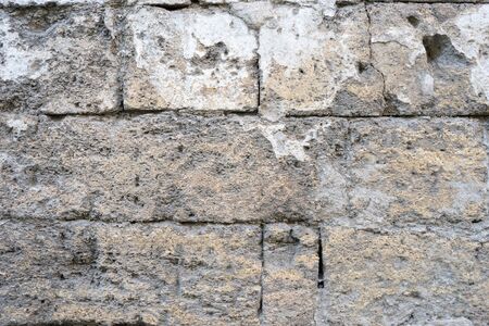 Abstract brick wall background with scuffs and cracksの写真素材