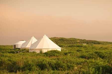 White tent on the background of the natural landscape. Travel and tourism.の写真素材