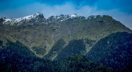 Natural landscape with mountains and forests against the sky.の写真素材