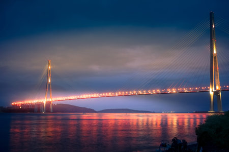 Vladivostok, Russian bridge. Night photos on a long exposure. Beautiful reflection on the surface of...