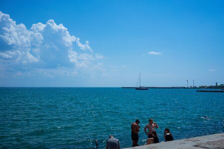 Evpatoria, Crimea - may 24, 2018: Seascape with people on the city's waterfront.のeditorial素材