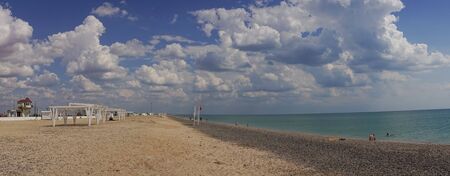 Evpatoria, Crimea - may 24, 2018: Panorama of the coastline with a beautiful white beach. People sunbathe and swim on a Sunny day.のeditorial素材