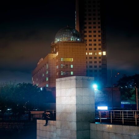 Vladivostok, Russia - August 18, 2019: Night landscape overlooking a modern hotel, billboards and people. Vladivostok, Russiaのeditorial素材