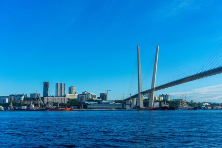 Vladivostok, Russia - August 11, 2018: Urban landscape with views of the Golden bridge and the architecture of the city.のeditorial素材