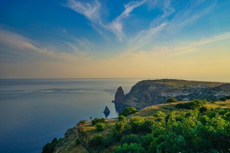 Seascape with coastline covered with vegetation.の写真素材