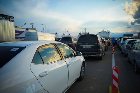 Port Caucasus, Russia-June 11, 2015: Ferry Taman-Kerch with cars and ferry in the evening.のeditorial素材