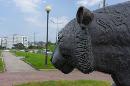 Vladivostok, Primorsky Krai-September 3, 2019: Sculpture of a tiger on a blurred background of the urban landscape.のeditorial素材