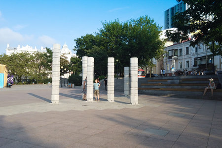 Vladivostok, Primorsky Krai - August 6, 2019: Cityscape with stone composition on the waterfront. Concrete pillars symbolize the hills located in the city.のeditorial素材