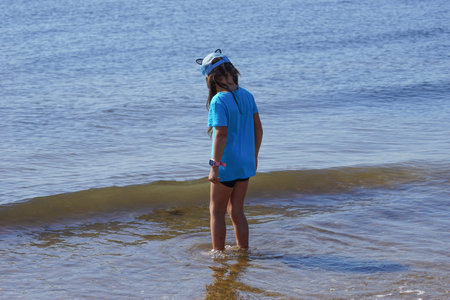 Vladivostok, Primorsky Krai-September 16, 2019: a Girl in blue clothes on a seascape background.のeditorial素材