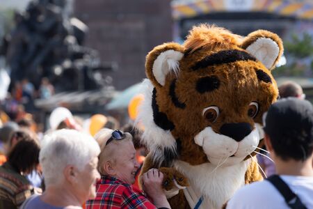 Vladivostok, Primorsky Krai-September 29, 2019: City square with people and cars during Tiger Day celebrations. The carnival is dedicated to the protection of ecology and the far Eastern tigers.のeditorial素材