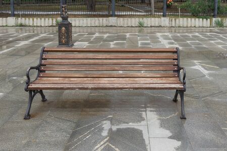 Cityscape with a wooden bench on the embankment of Sudak, Crimea.の写真素材