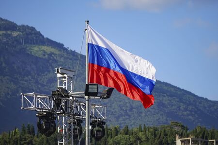 Russian flag on the background of mountains in Yalta, Crimeaの写真素材