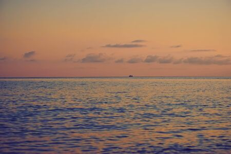 Sunset over the sea surface. Beautiful sky above the horizon.の写真素材