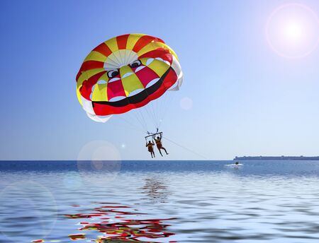 People flying on a parachute on the background of the seascape.のeditorial素材