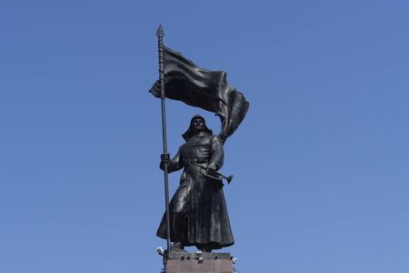 Vladivostok, Primorsky Krai-September 29, 2019: Cityscape with a sculpture of a warrior against the blue sky.のeditorial素材
