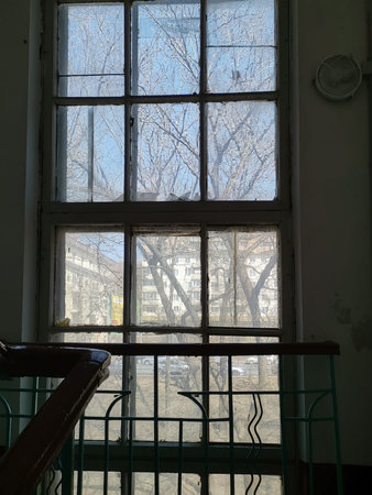 Window in the entrance of the old house. Vladivostok, Russia