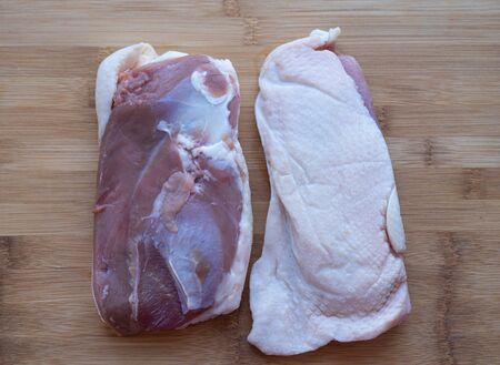 Turkey fillet on a background of bamboo cutting Board.の写真素材
