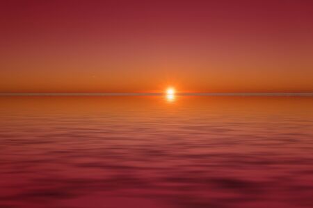 Seascape with a beautiful sunset over the horizon and the water surface.の写真素材