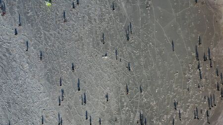 Aerial view of the icy surface of the sea with fishermen. Vladivostok, Russiaの写真素材