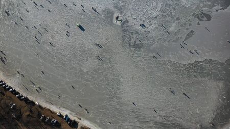 Aerial view of the icy surface of the sea with fishermen. Vladivostok, Russiaの写真素材