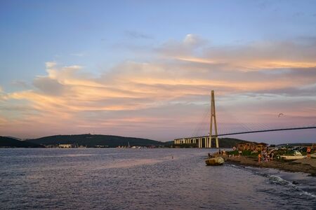 Seascape with a view of the Russian bridge at sunset. Vladivostok, Russiaのeditorial素材