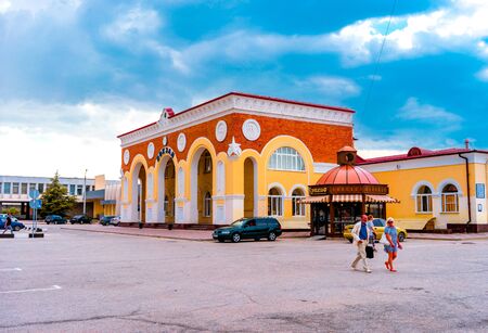 Evpatoria, Crimea-may 23, 2018: Urban landscape with a view of the railway station. People walk along the station square.のeditorial素材