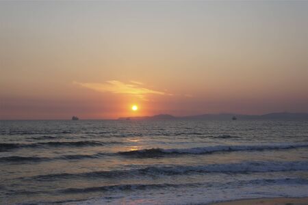 Seascape with sunset view. Seascape with sunset view. The sun is on the horizon.の写真素材