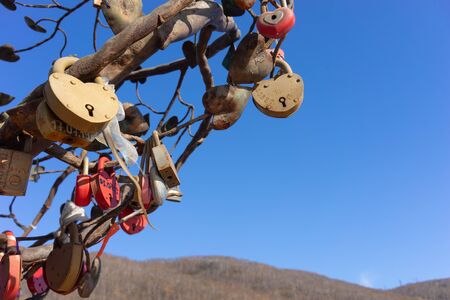 Petropavlovsk-Kamchatsky, Russia-October 8, 2019: Metal tree of lovers on a background of blue sky.のeditorial素材