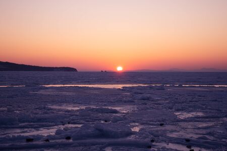 Seascape with sunset view over the icy surface. Vladivostok, Russiaの写真素材