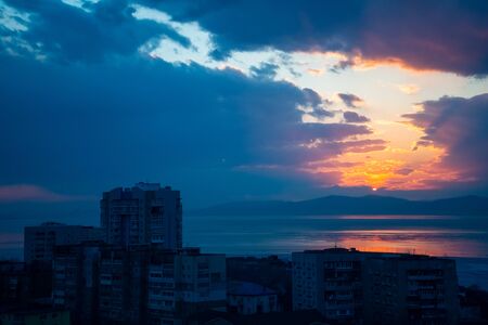 Sunset on the background of the sea and urban landscape, Vladivostok, Russiaの写真素材