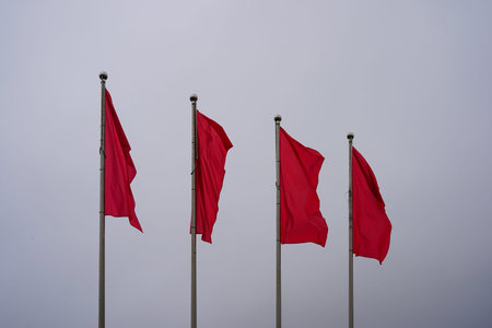 Red flags against a hazy sky.