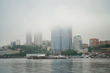 Vladivostok, Russia-July 6, 2020: Urban landscape with a view of buildings in the fogのeditorial素材
