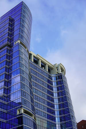 Vladivostok, Russia-July 6, 2020: A skyscraper made of blue glass and concrete against the skyのeditorial素材
