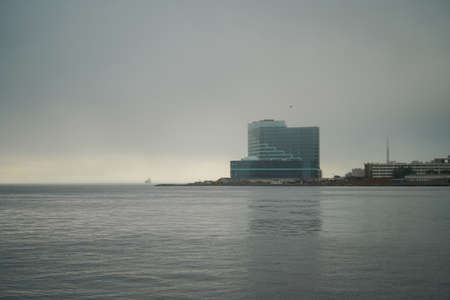 Vladivostok, Russia-July 6, 2020: Seascape with buildings near the shore in the fogのeditorial素材