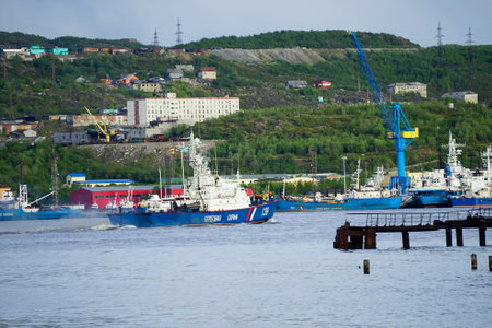 Murmansk, Russia-June 5, 2015: Border ship in the Kola Bay on the background of the city.のeditorial素材