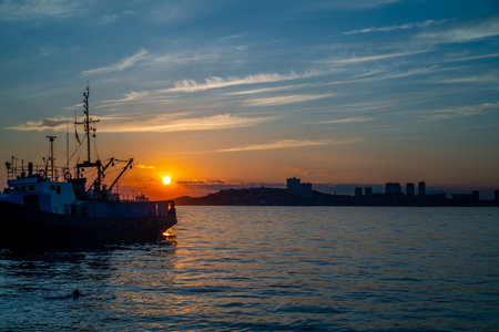 Seascape with a ship on the background of the sunset. Vladivostok, Russiaの写真素材