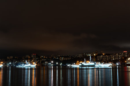 Vladivostok, Russia - July 23, 2020: Night landscape with views of the Golden Horn Bay and the ship. Preparing for the celebration of the day of the Navy.のeditorial素材