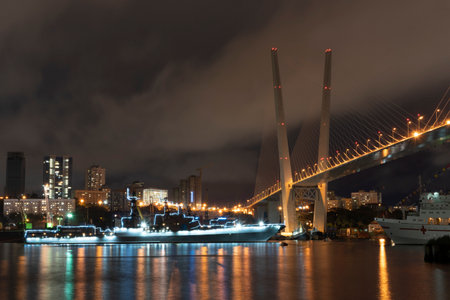 Vladivostok, Russia - July 23, 2020: Night landscape with views of the Golden Horn Bay and the ship. Preparing for the celebration of the day of the Navy.のeditorial素材