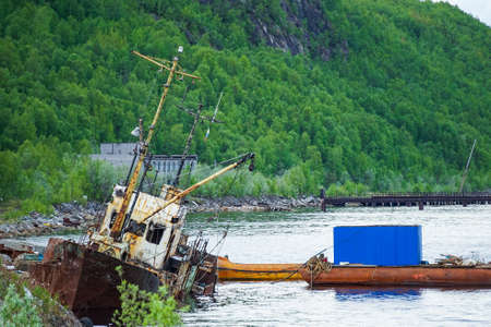 Murmansk, Russia-June 5, 2015: Landscape with old ships at the pier in the Kola Bay.のeditorial素材