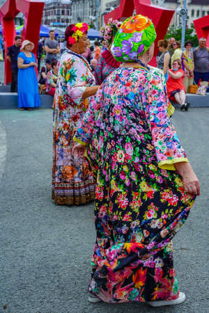 Vladivostok, Russia - July 26, 2020: Portraits of elderly women against the backdrop of the city landscape on a holiday.のeditorial素材