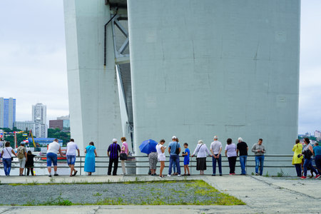 Vladivostok, Russia - July 26, 2020: Urban landscape with people at the columns of the Golden bridge.のeditorial素材
